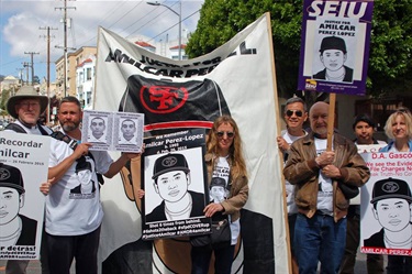 A group of people holding graphic posters. 