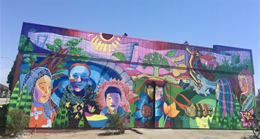 A colorful mural painted on the wall of a building. 