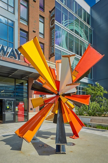 A large abstract sculpture in a building entryway.