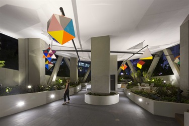 Sculptures suspended on a wall in an open space. 
