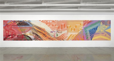 A colorful piece of artwork installed on a wall. 
