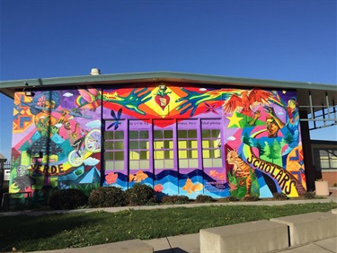 A colorful mural painting on the side of a building. 