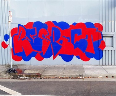 Red and blue graffiti on a wall. 