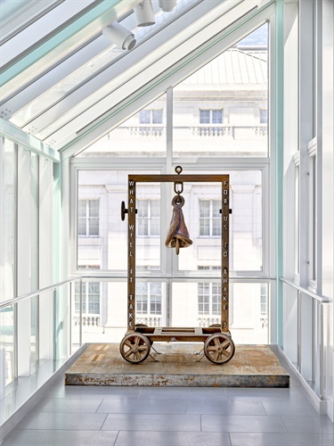 An abstract sculpture in a glass room. 