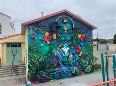 A colorful mural on the side of a building. 