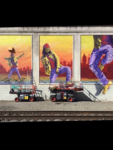 A colorful mural series of three images on the side of a building. 