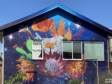 A mural on the wall with a series of flowers.