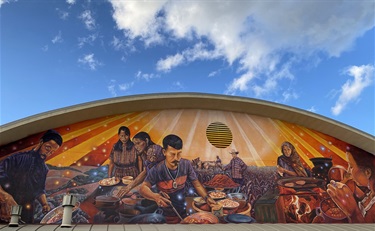 A mural on the wall with a series of portraits. 