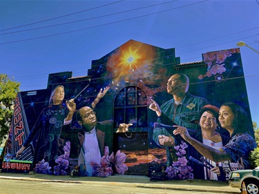 A mural on the wall with a series of portraits. 