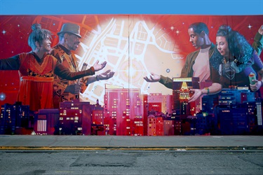 A mural on the wall with a series of portraits. 