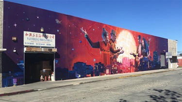 A mural on the wall with a series of portraits. 