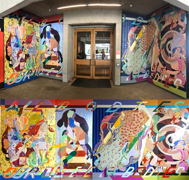 Colorful murals on the wall of a room. 