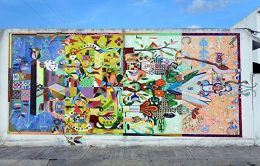 A colorful mural on the side of a wall. 
