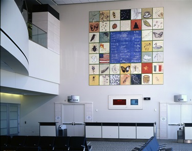 An art installation on the wall of an airport gate area.