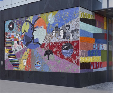 A mosaic tile mural covering the corner of a building.