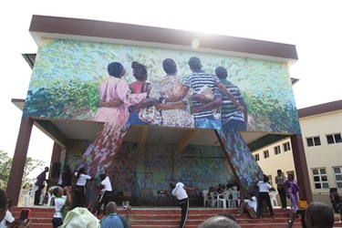 A mural painted above the entrance of a building. 