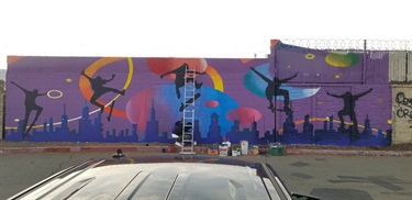 A brightly colored mural on the side of a building. 