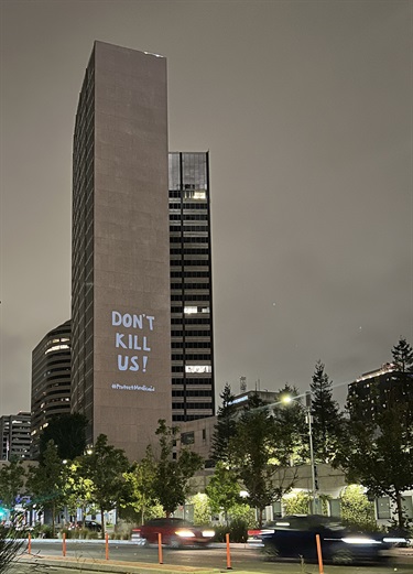 A tall grey building. 