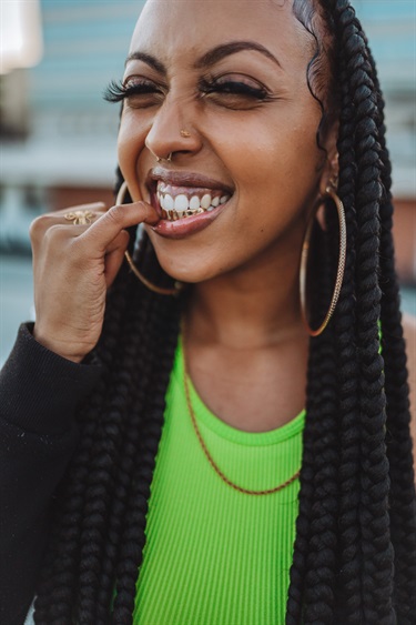 A person with their finger on their lip. 