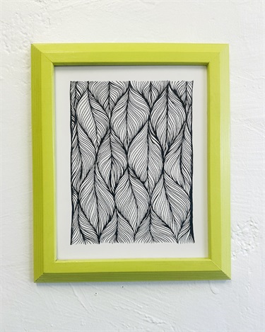 A framed abstract piece of artwork.