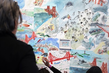 A person looking at a piece of artwork. 