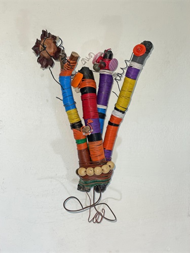 An abstract sculpture on a white wall. 