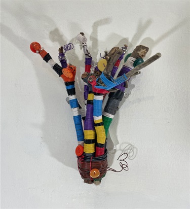 An abstract sculpture on a white wall. 