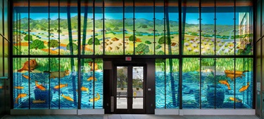 Glass artwork installed on the wall of a building. 