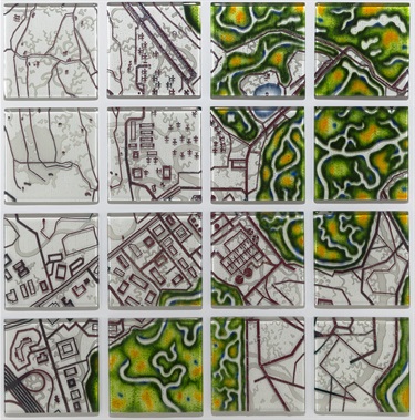 A series of glass artwork pieces showing a map. 