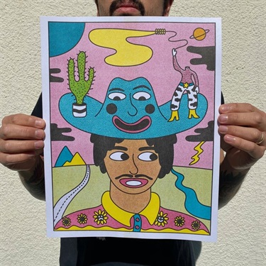 A person holding a print of an artwork. 