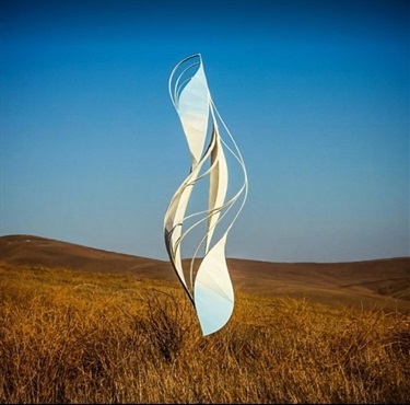 An abstract sculpture in a field. 