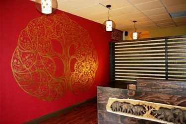 A gold painting on a red wall. 