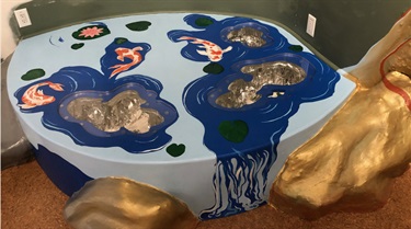 A blue, white, and gold abstract sculpture.