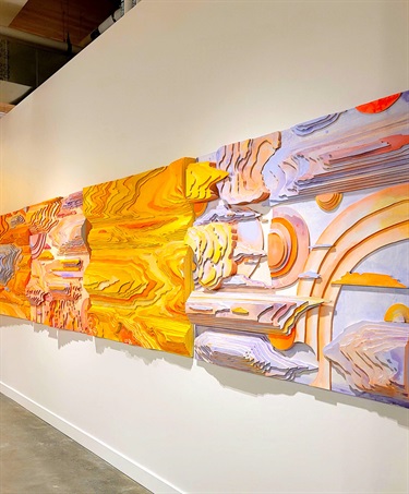 Colorful artwork on a white wall.