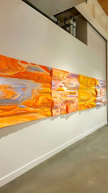 Colorful artwork on a white wall.