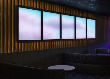 A video installation on a wall in a room.