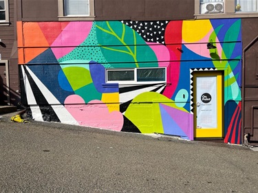 A colorful mural on the wall of a building. 