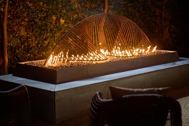 A sculpture sitting on a fireplace.