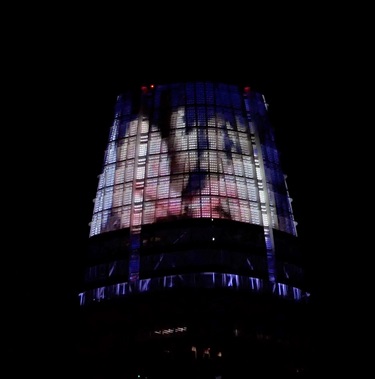 The top of a building with projected artwork.