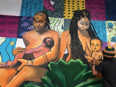 A painting of two women and children. 