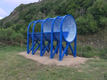 An abstract blue structure surrounded by nature. 