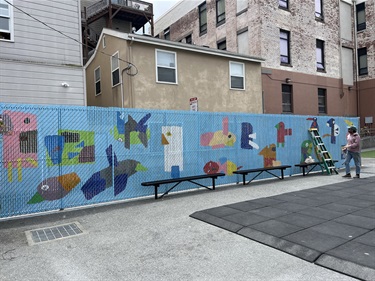 A mural painted on a fence. 