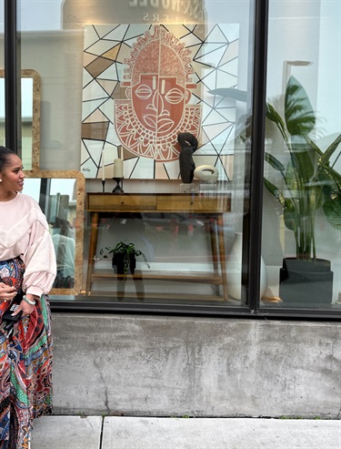 A person standing in front of a storefront.