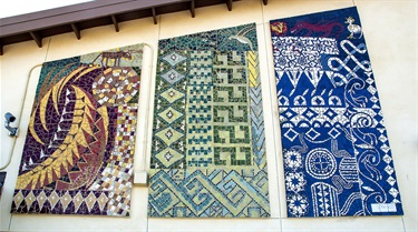 A tile mosaic installation on the side of a building. 