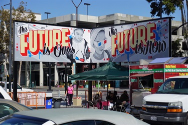 A billboard above a city street. 