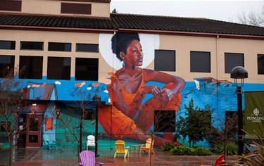 A large colorful mural on the side of a building. 