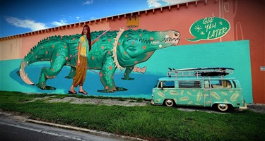 A large colorful mural on the side of a building. 