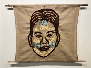 A piece of embroidered artwork. 