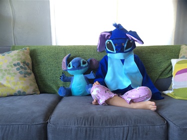 A person sitting on a couch in a costume.