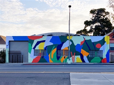 An abstract mural on the side of a building. 